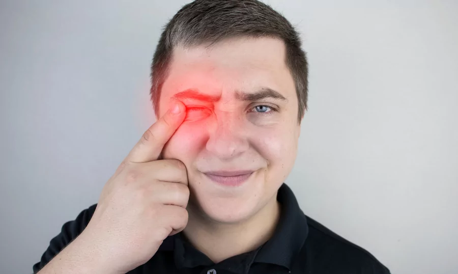 A man pointing his finger to an injured eye