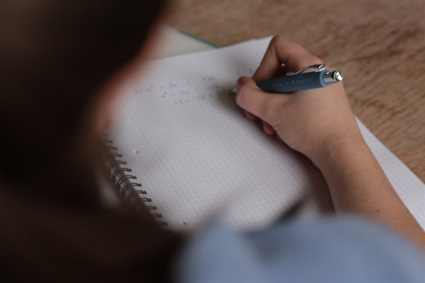 A woman making notes in a notepad